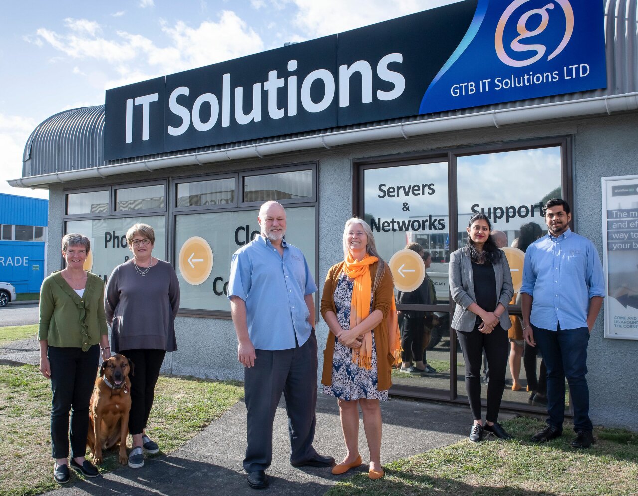 Whole GTB Team outside GTB IT Solutions Paraparaumu offices. Sign above them reads IT Solutions.